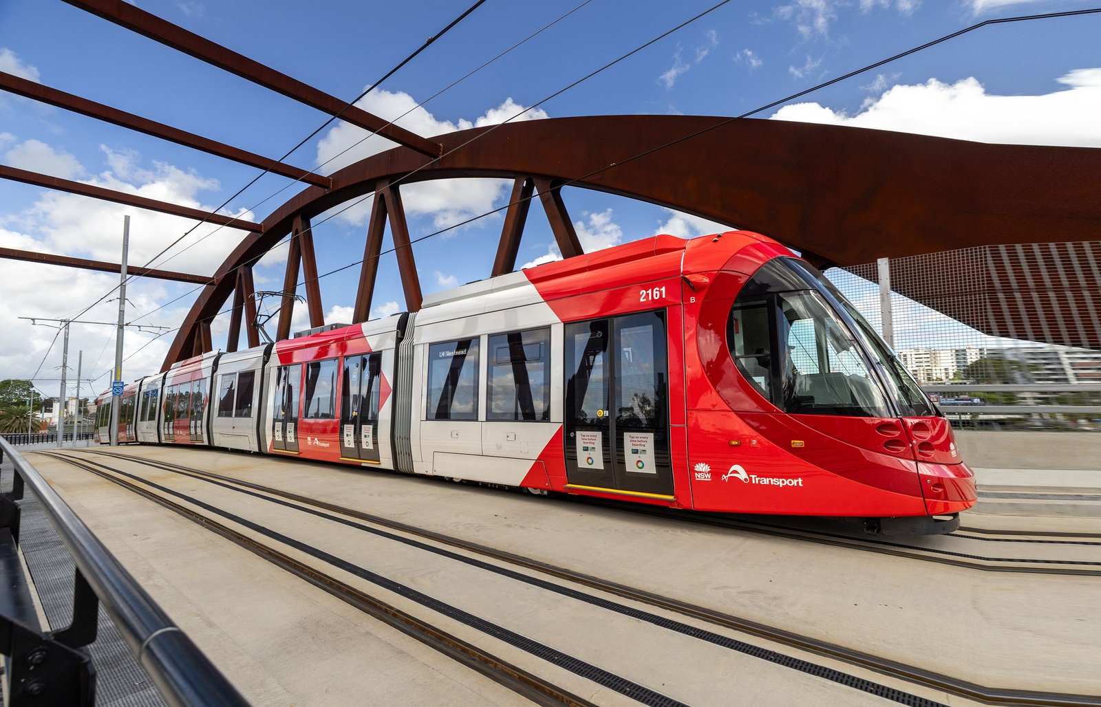 Parramatta Light Rail tram beneath a steel bridge