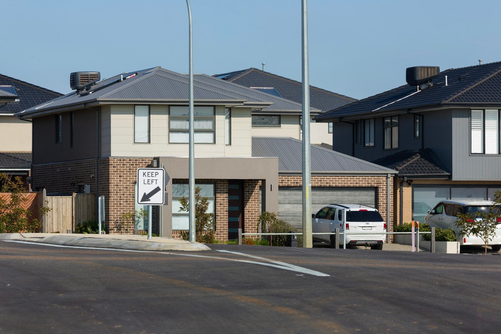 Representative image: Modern houses with grey roofs and brick accents