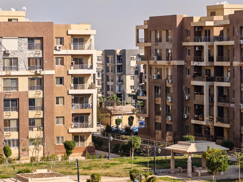 Representative image: Contemporary apartment buildings with balconies and green spaces captured in daylight