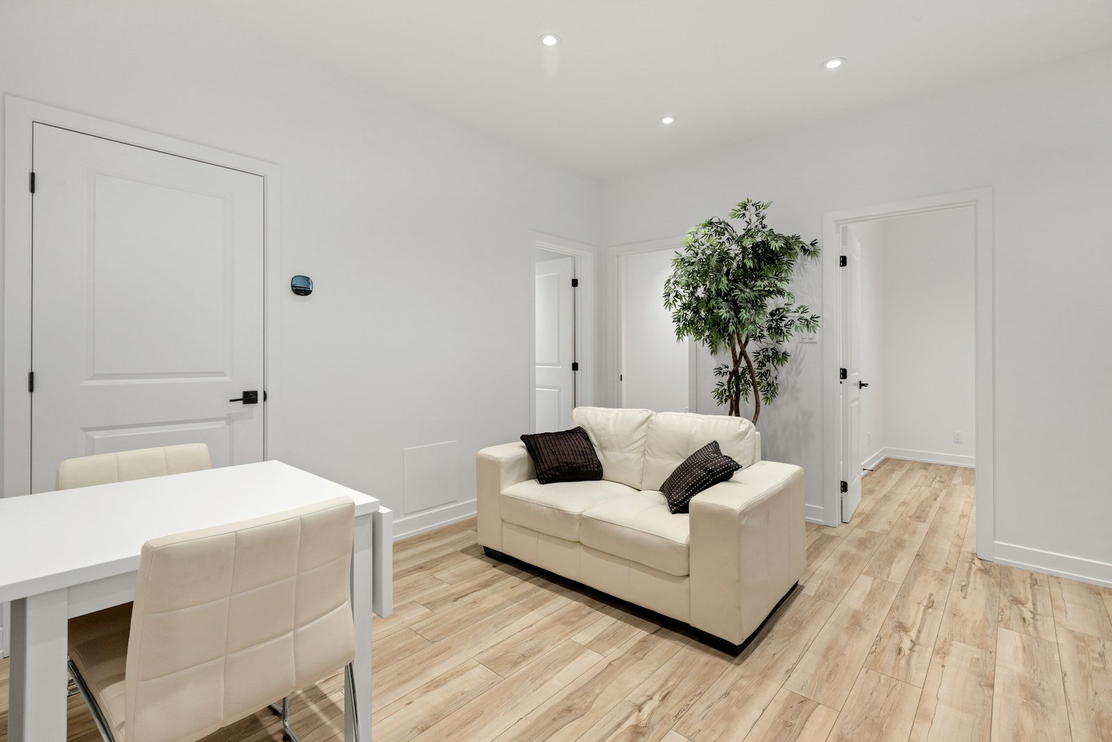 Representative image: a living room with a white couch and a table