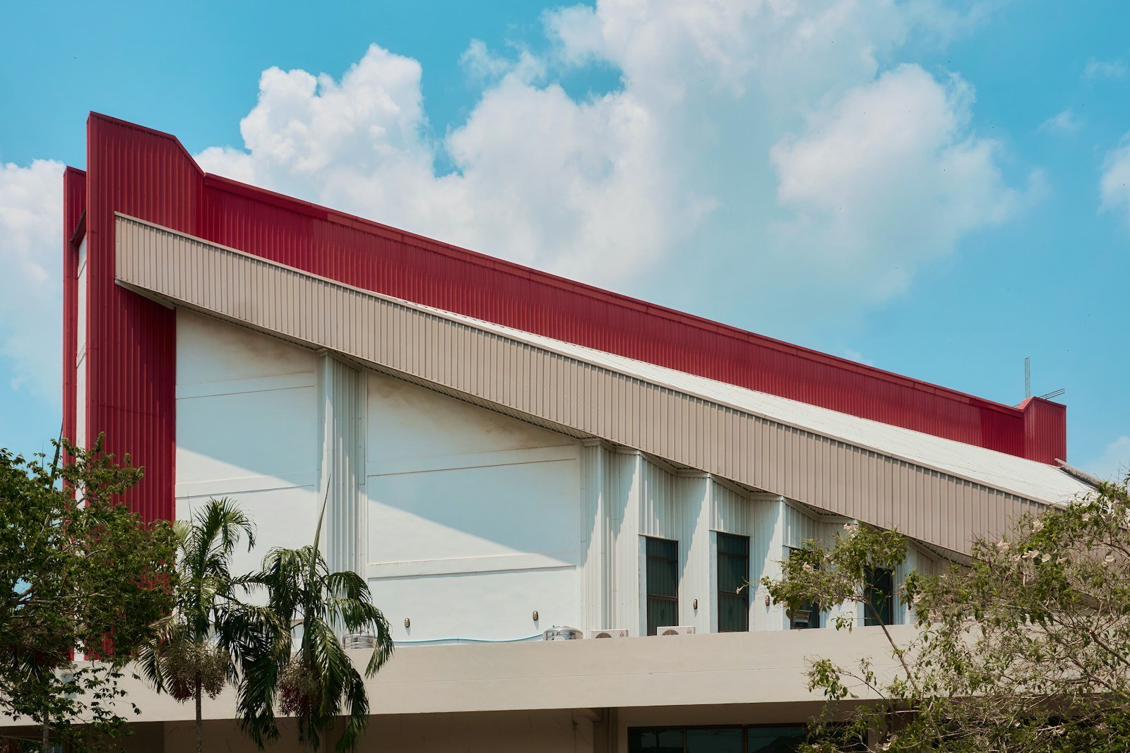 Representative image: Modern building with red and white facade under blue sky
