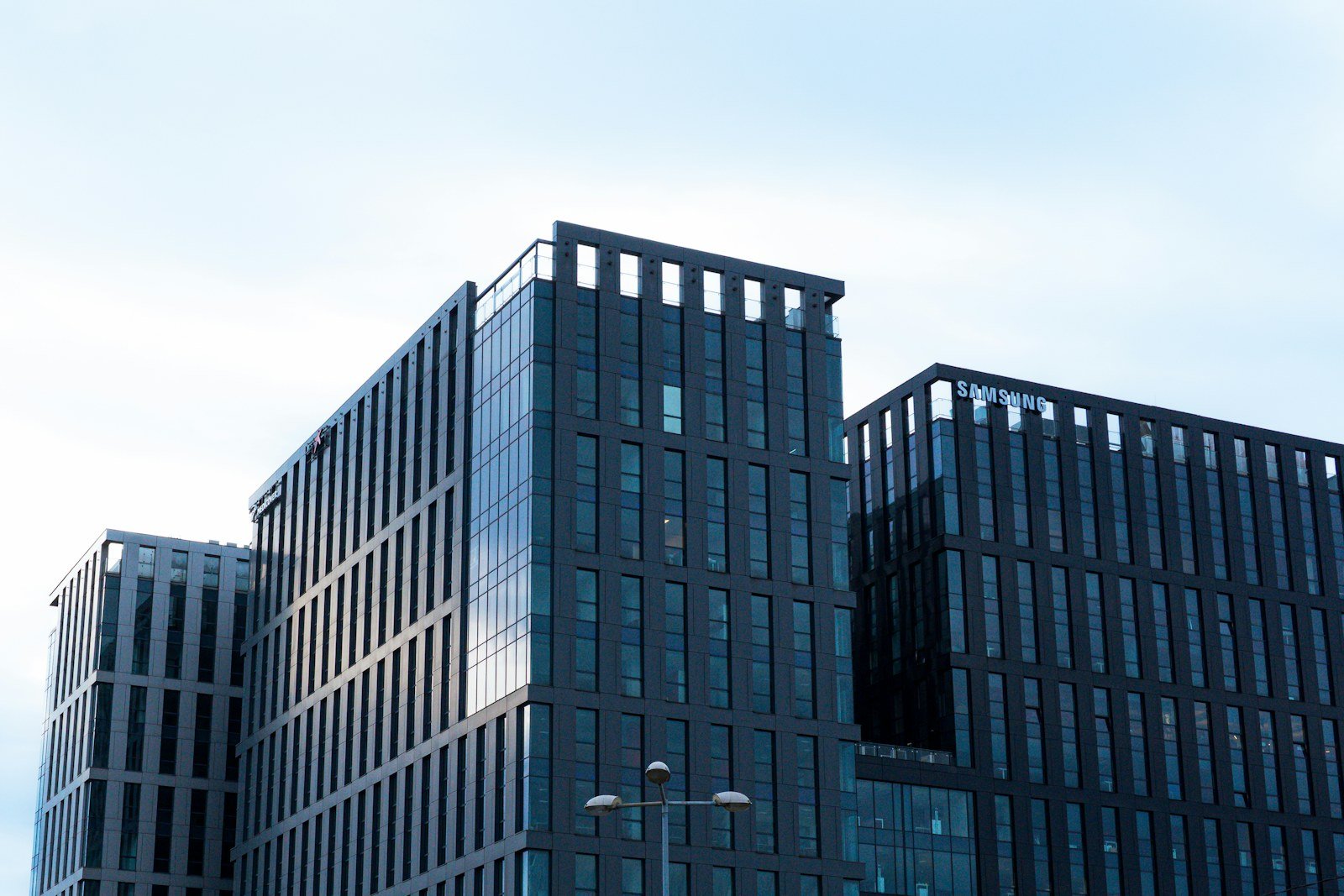 Representative image: Modern glass office buildings against a pale sky