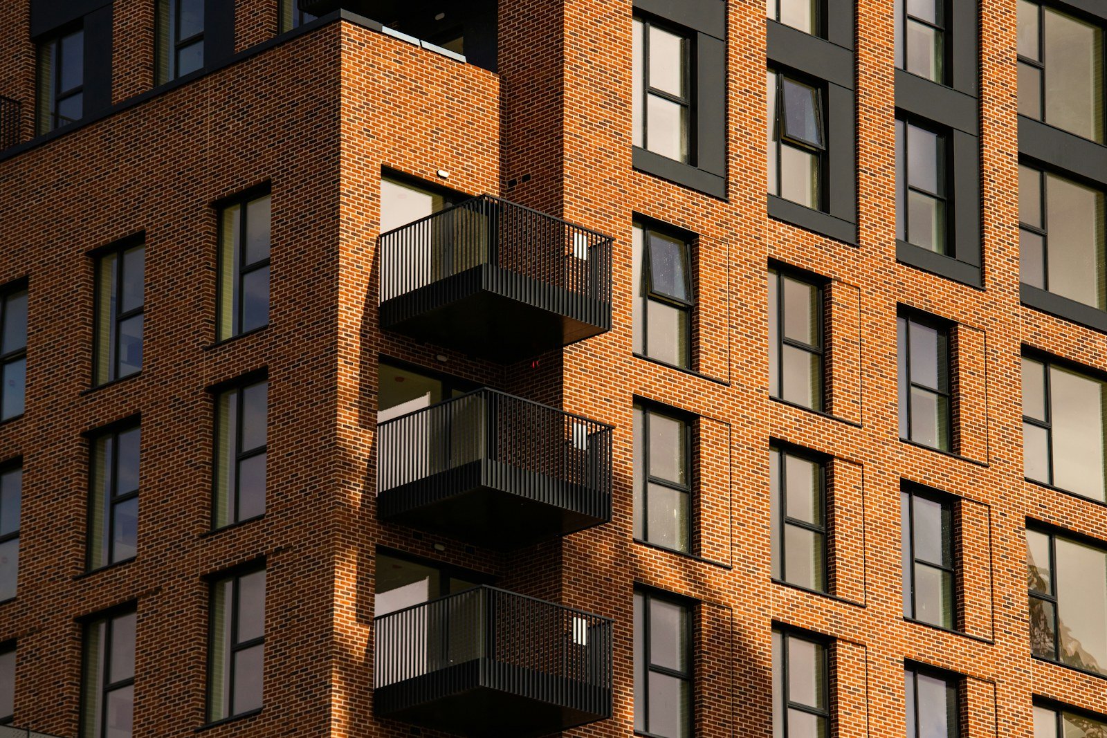 Representative image: Modern brick building with numerous windows and small balconies