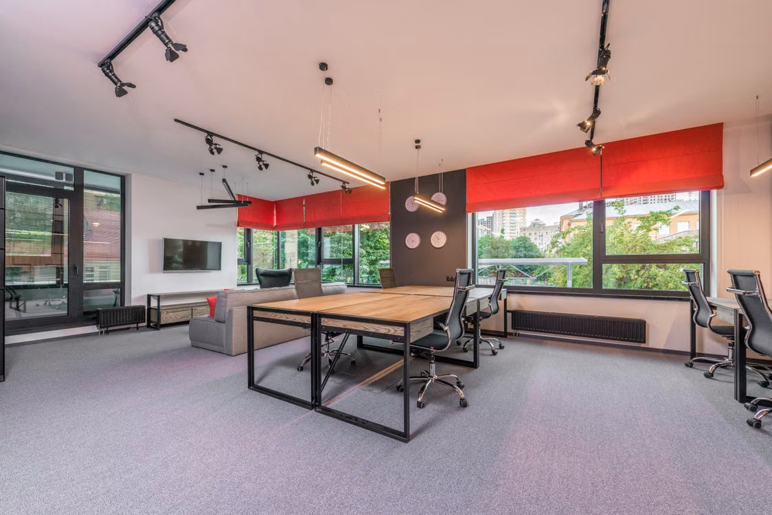 Representative image: Contemporary workspace interior with armchairs and tables against TV and sofa under lamps hanging on ceiling