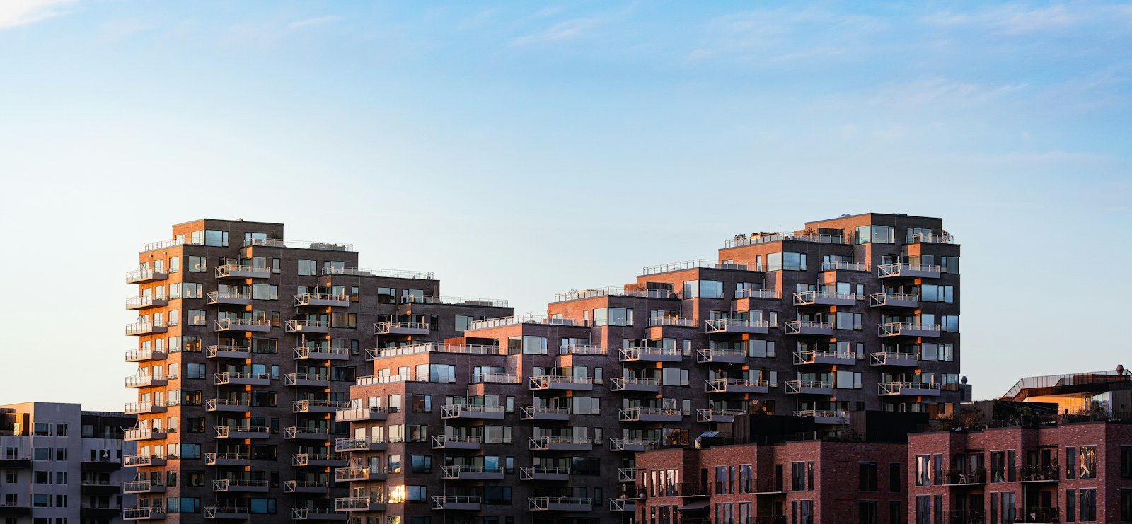 Representative image: Modern apartment buildings with balconies under a clear blue sky