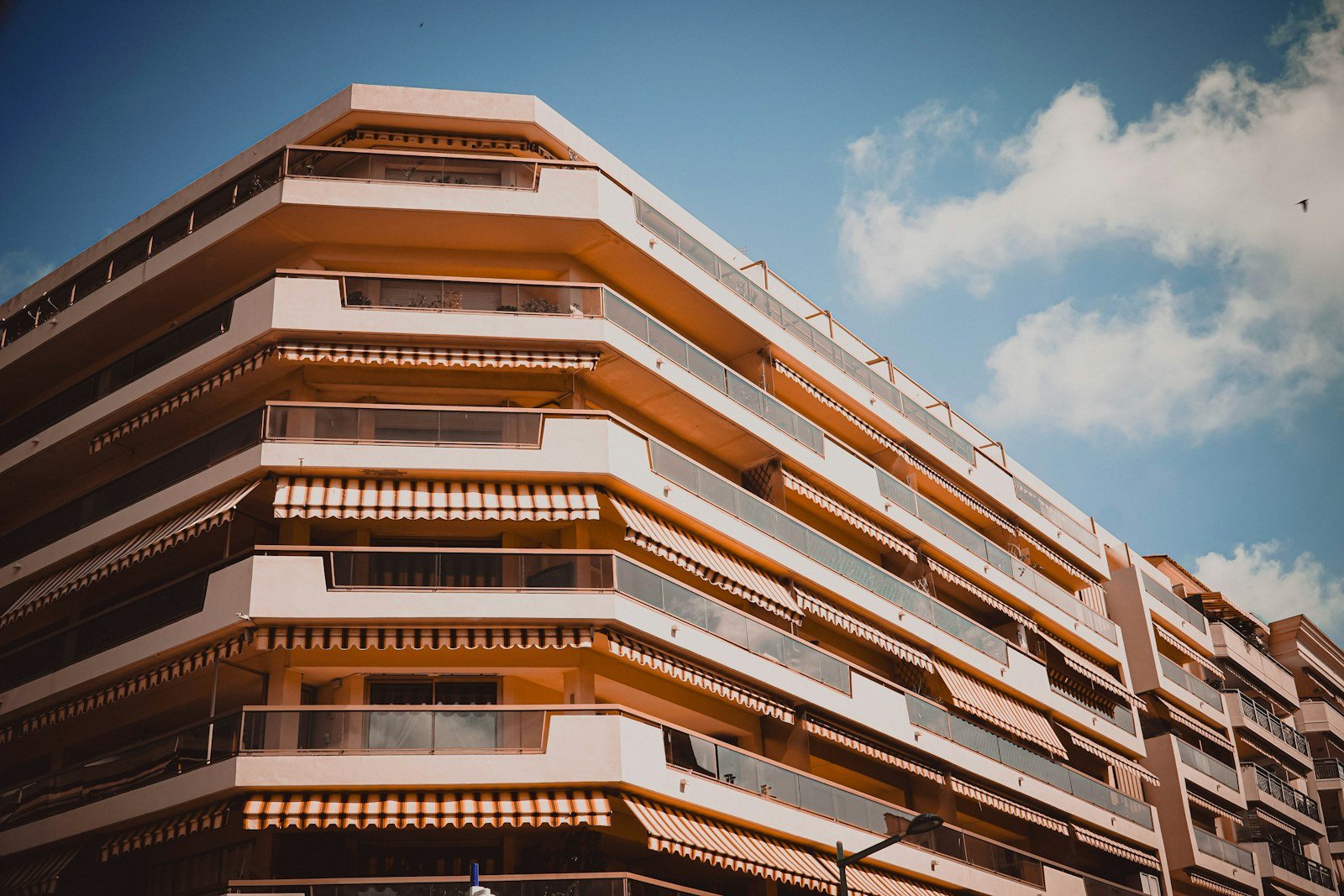 Representative image: Modern apartment building with balconies and awnings